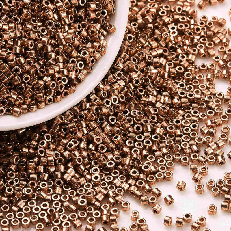 Seed beads, ca. 2x1,5 mm, mørk guld, ca. 5 gram