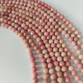 Rhodonite , rund 6 mm , hel streng