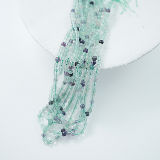Fluorescerende Kvarts，4mm rund，hel streng 37cm