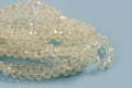 Glasperle, rondel, facet, klar, 5x6 mm, 1 streng