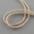 Glasperle, facetsleben, varm gylden, ca. 2x3 mm, 1 streng