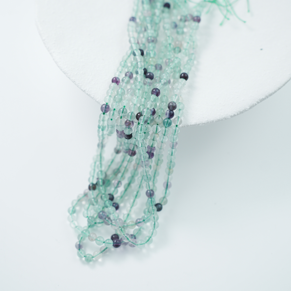 Fluorescerende Kvarts，4mm rund，hel streng 37cm