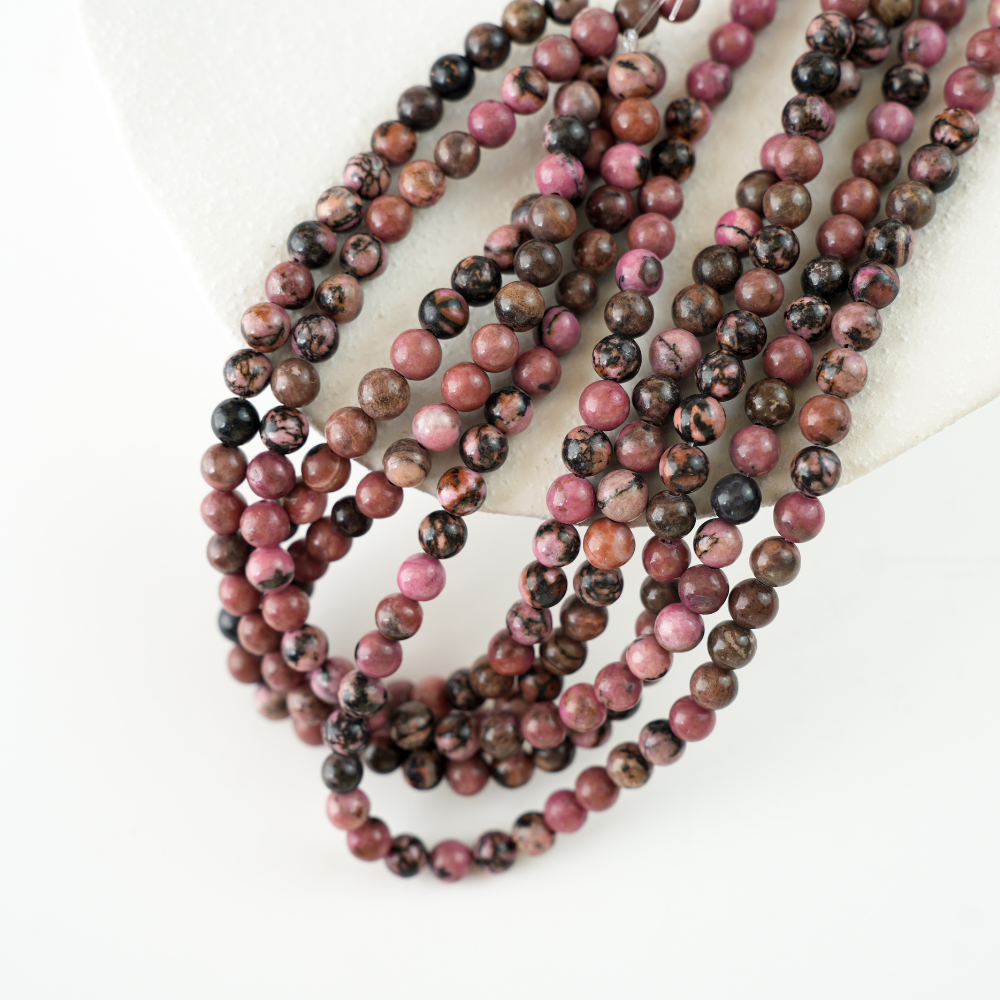 Rhodochrosit med sorte striber，6mm rund，hel streng 38cm